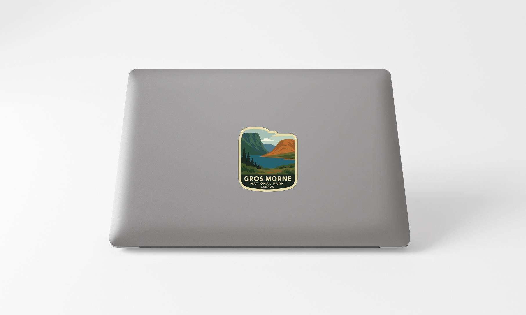 A sticker with a scenic landscape on a laptop.