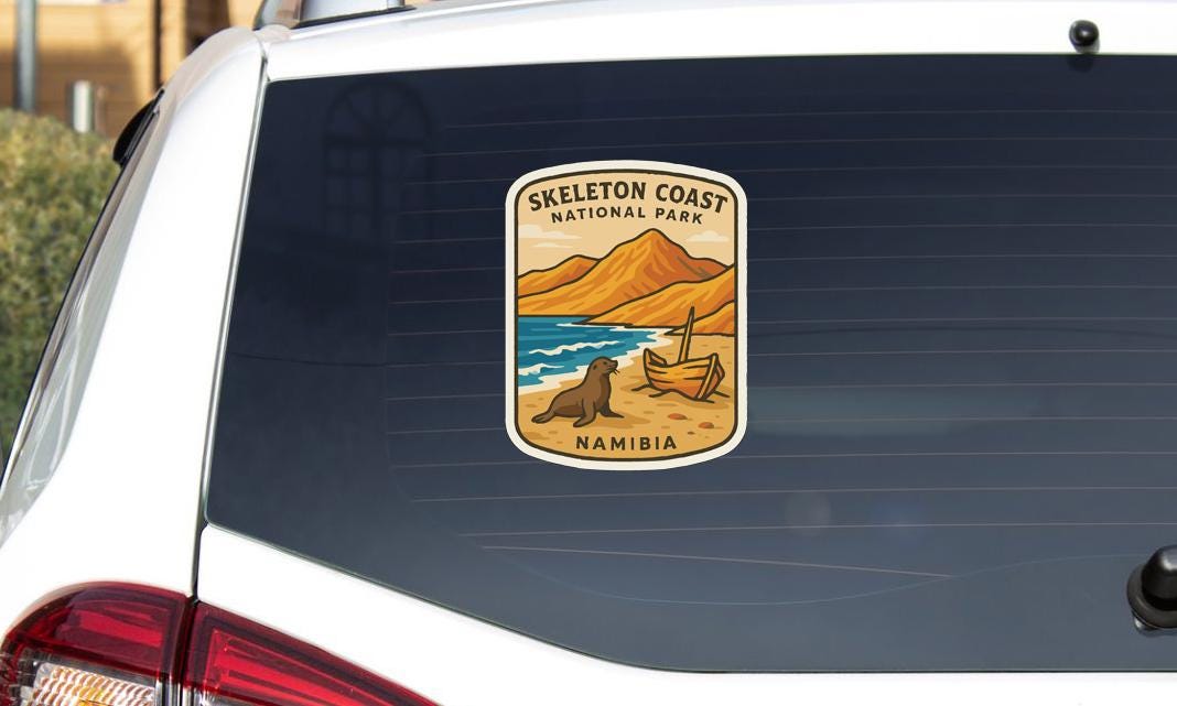 A sticker on the rear window of a car, depicting a scenic landscape with mountains, a beach, and a seal.