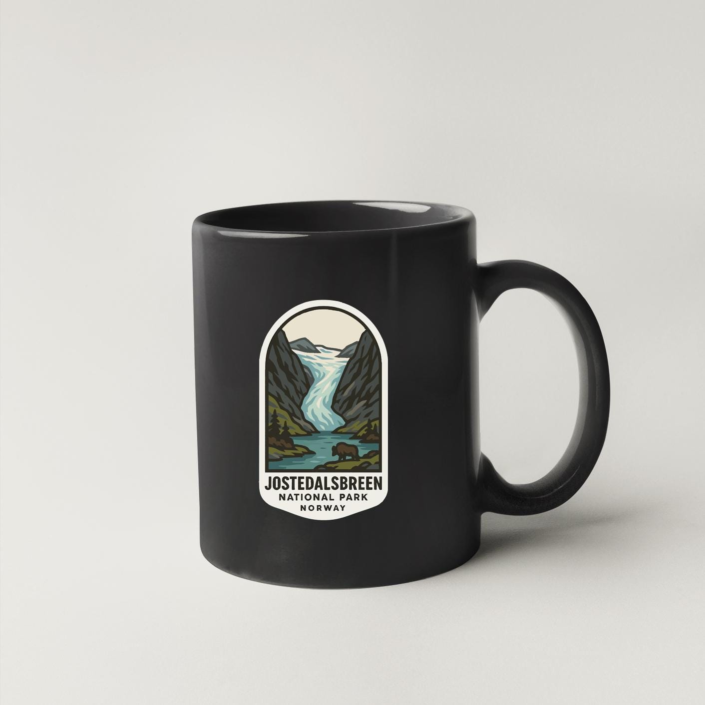 A black coffee mug with a label that says "Jstedalsbreen National Park Norway".