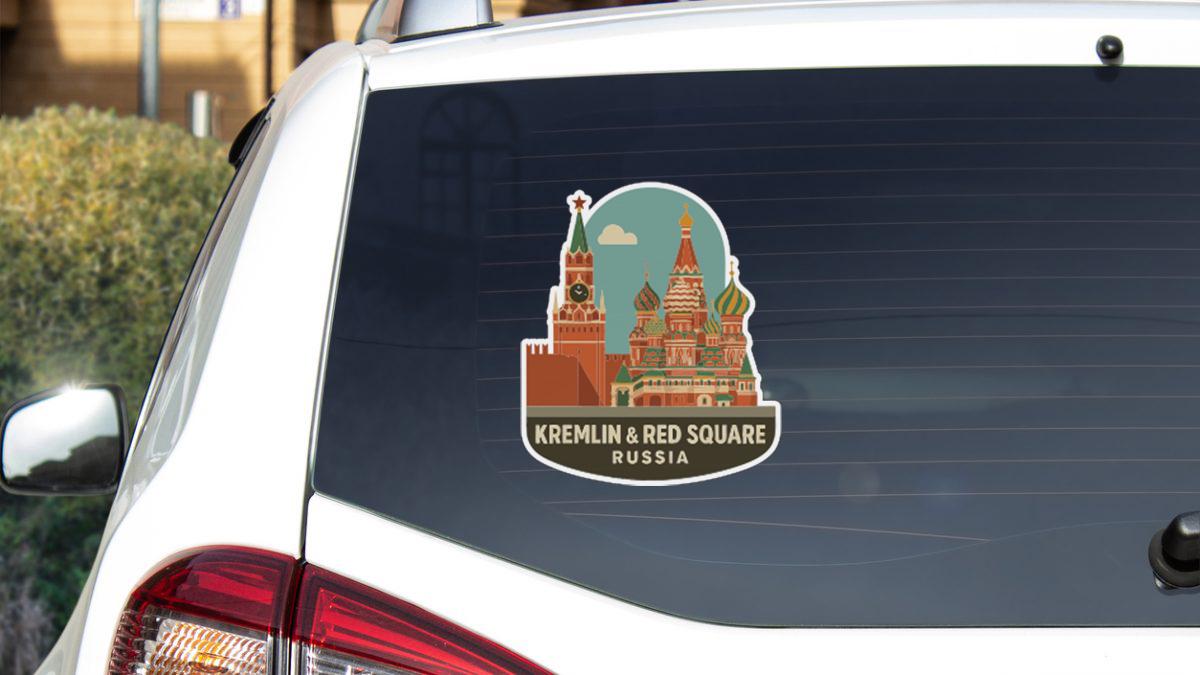 A sticker on the rear window of a car, depicting the Kremlin and Red Square in Russia.