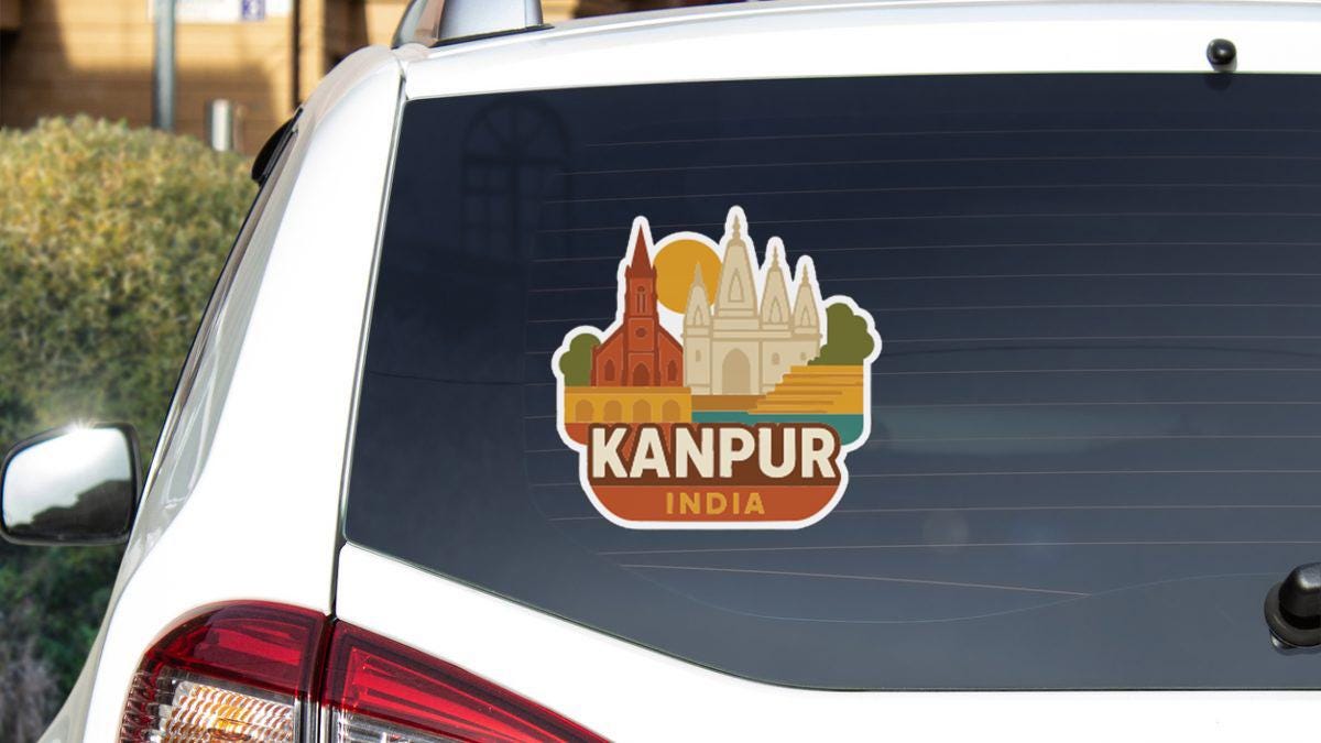 A sticker on the rear window of a car that says "Kanpur India".