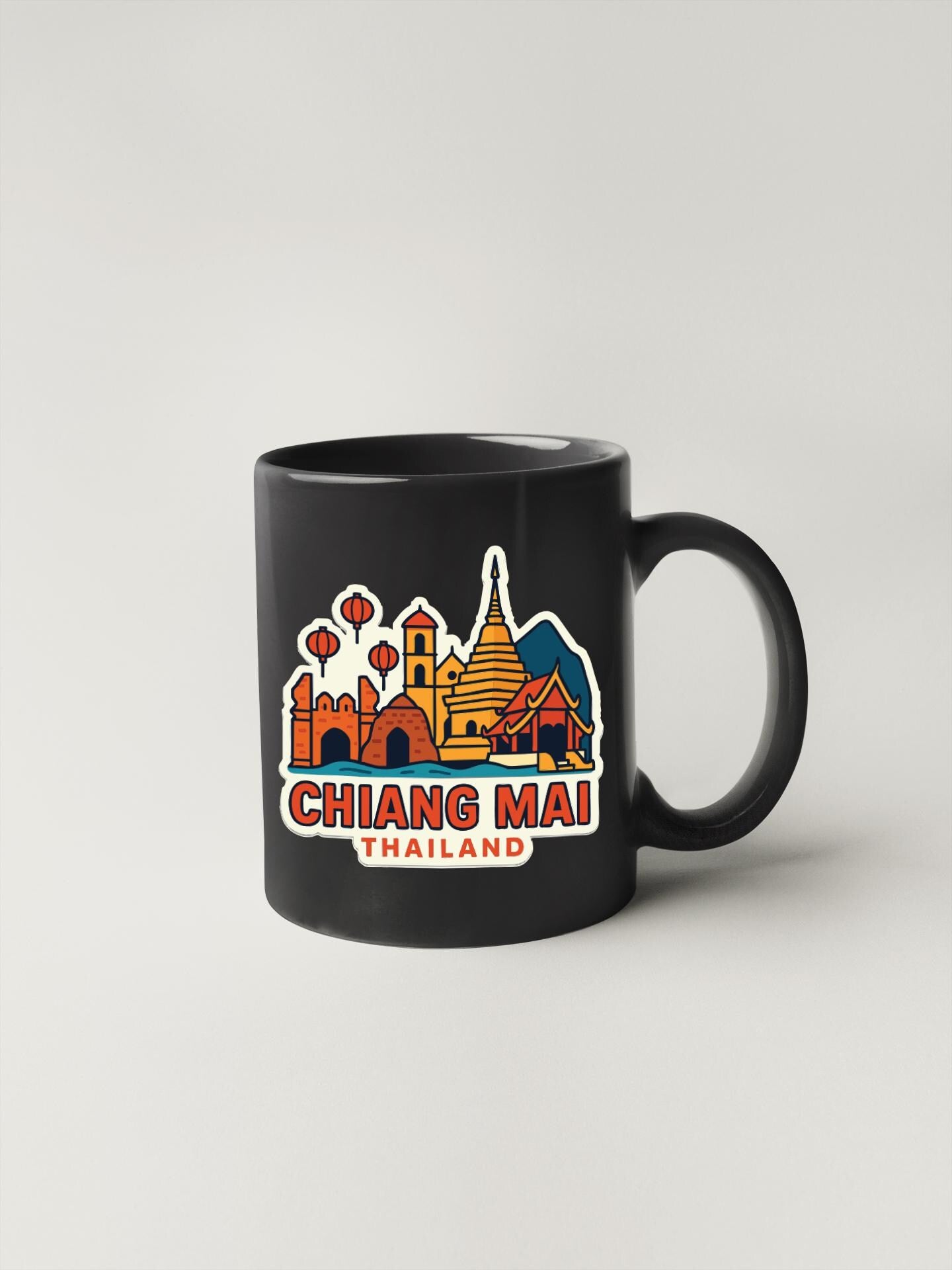 A black coffee mug with a colorful illustration of the skyline of Chiang Mai, Thailand, featuring various landmarks and buildings.