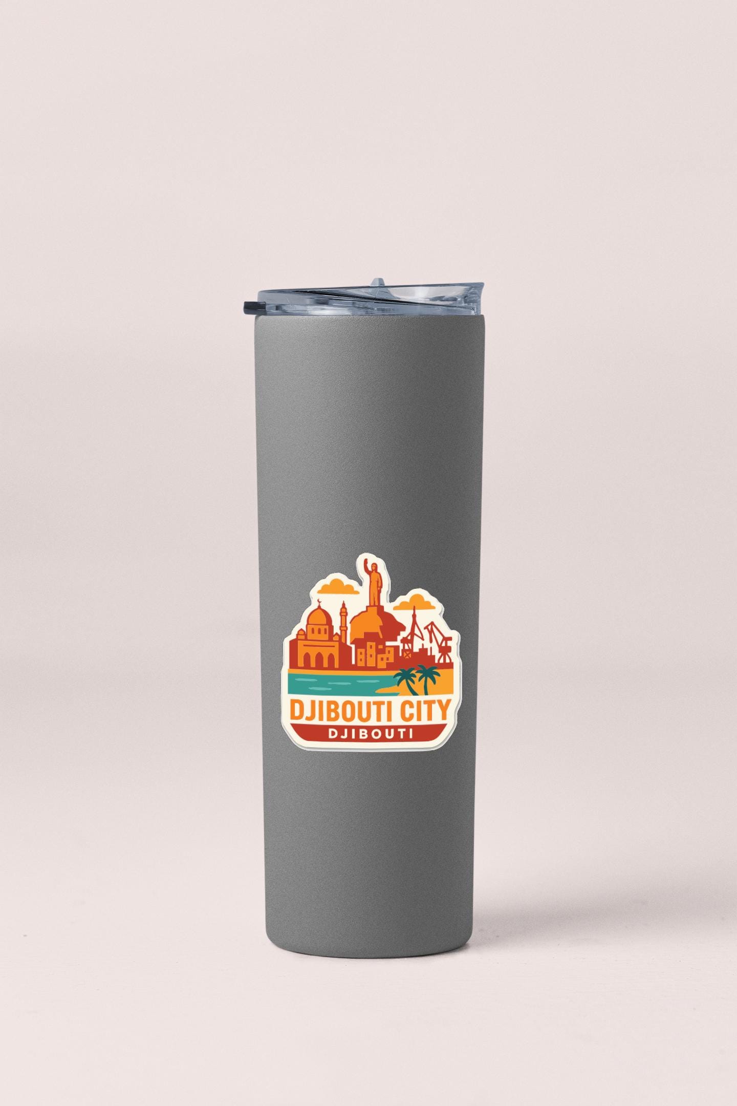 A gray insulated tumbler with a sticker depicting the city of Djibouti.