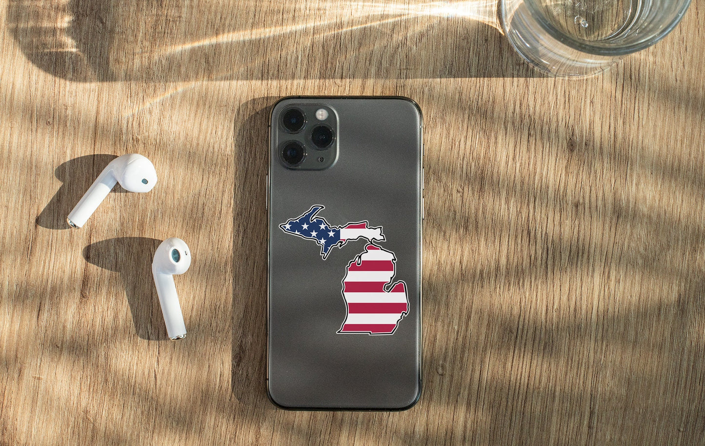 a cell phone with a sticker of the state of michigan