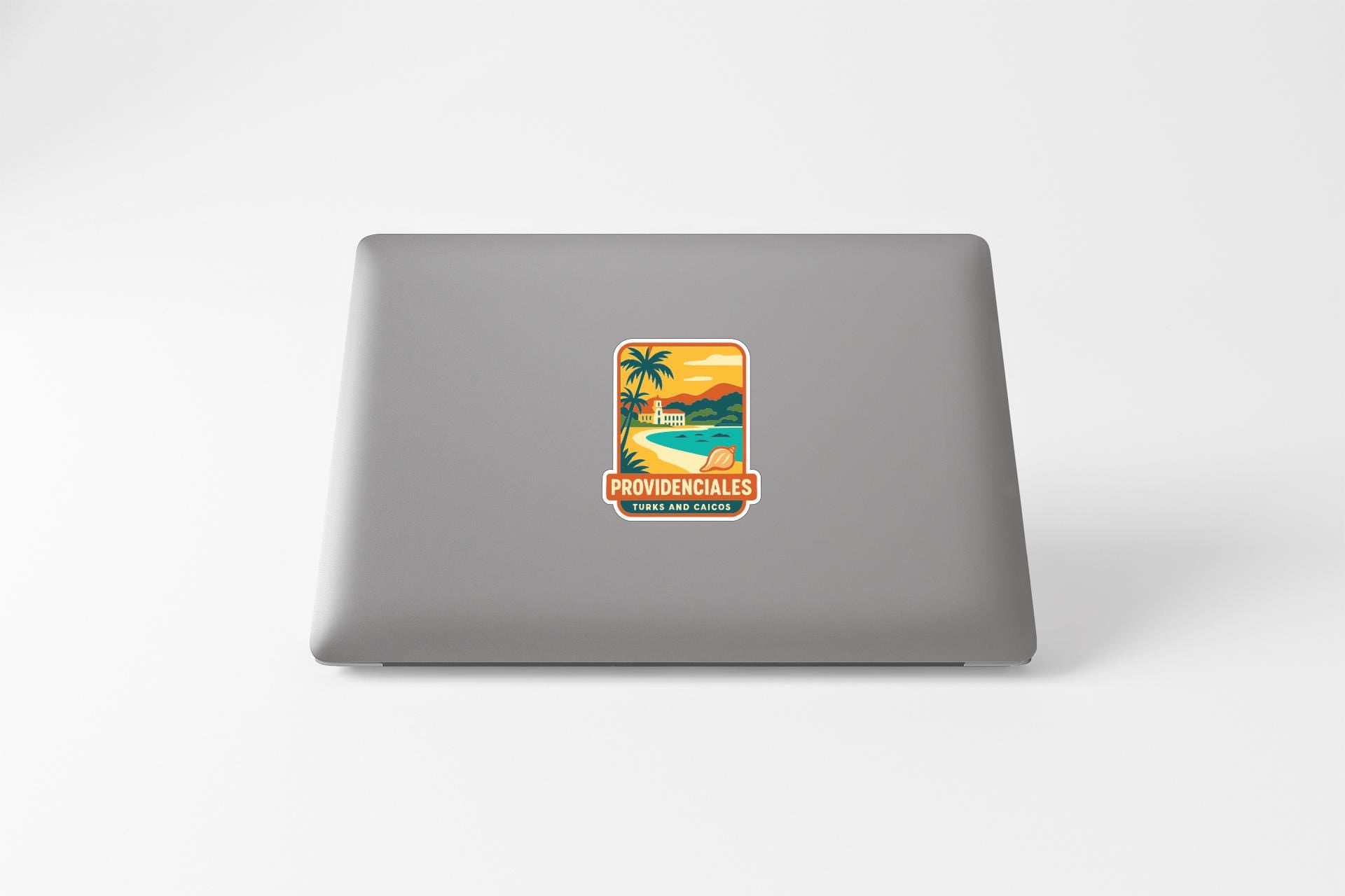a sticker on the back of a laptop that says "PROVIDENCIALES" and "TRAVEL AND PLACES".