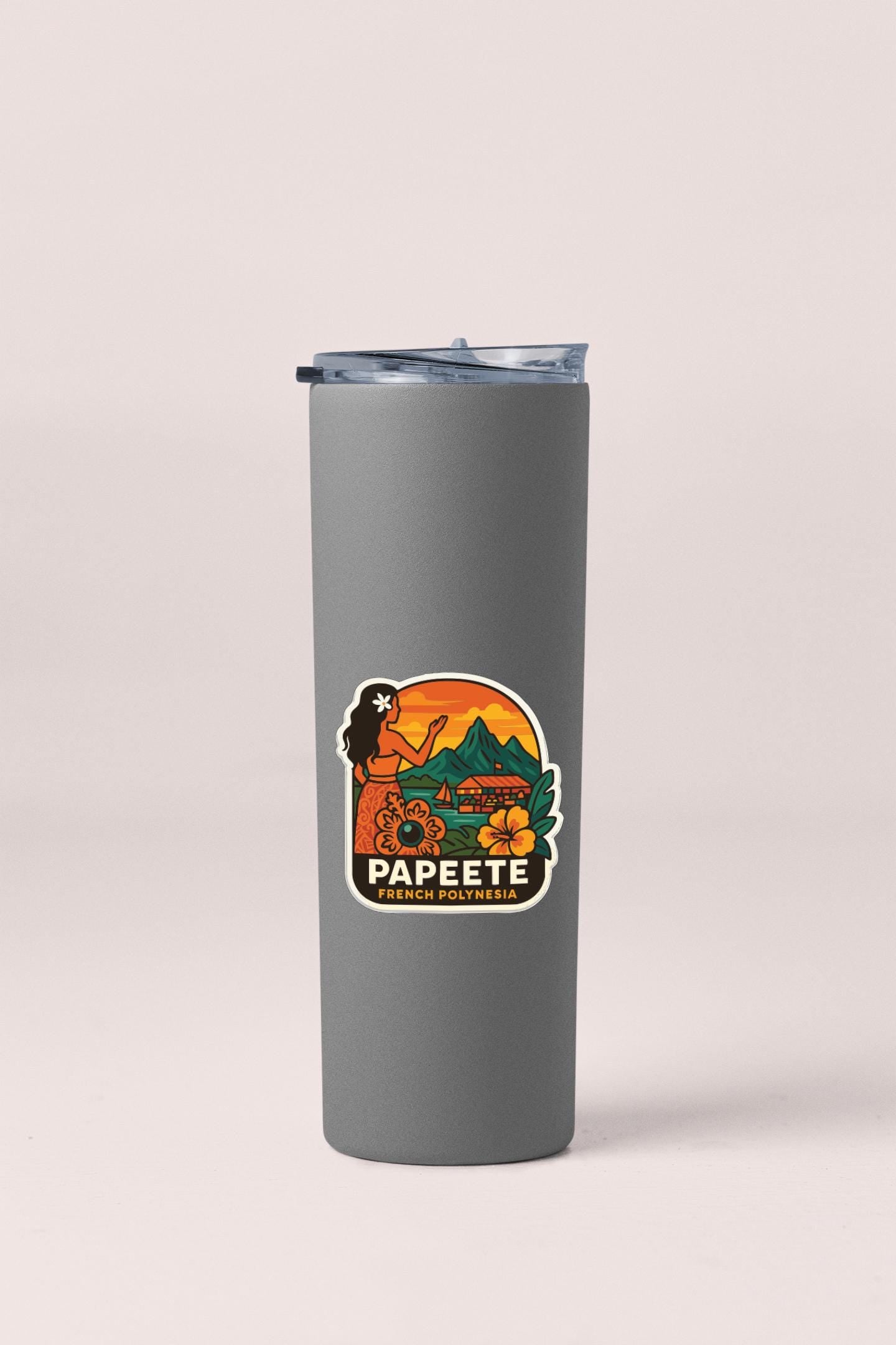 A gray insulated tumbler with a sticker depicting a woman and tropical scenery.
