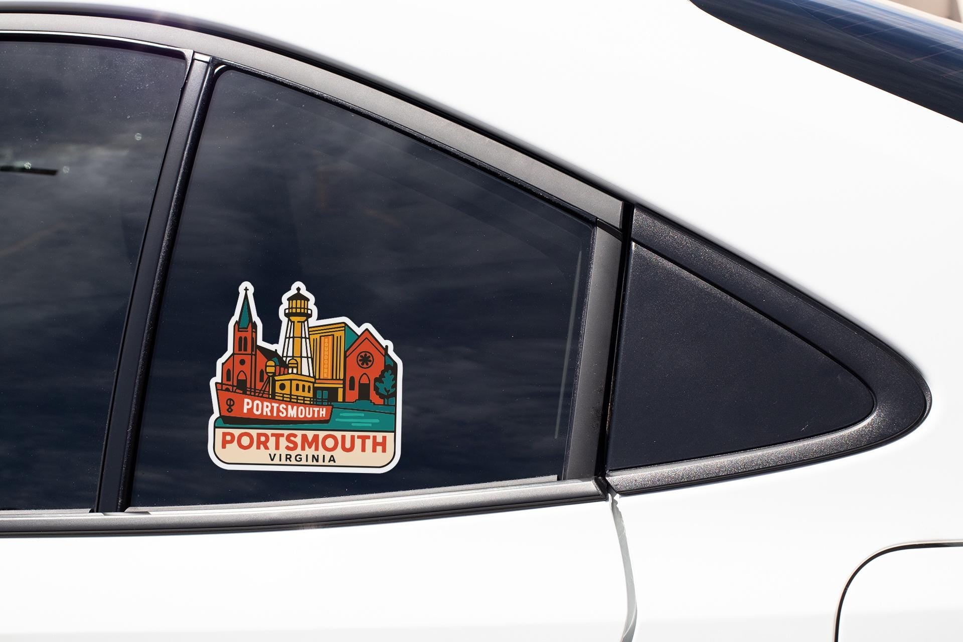 A sticker on the side of a car window, depicting a cityscape with a church and other buildings.