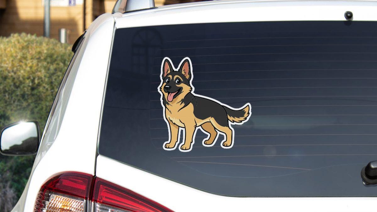 A sticker of a cartoon dog is on the rear window of a white car.