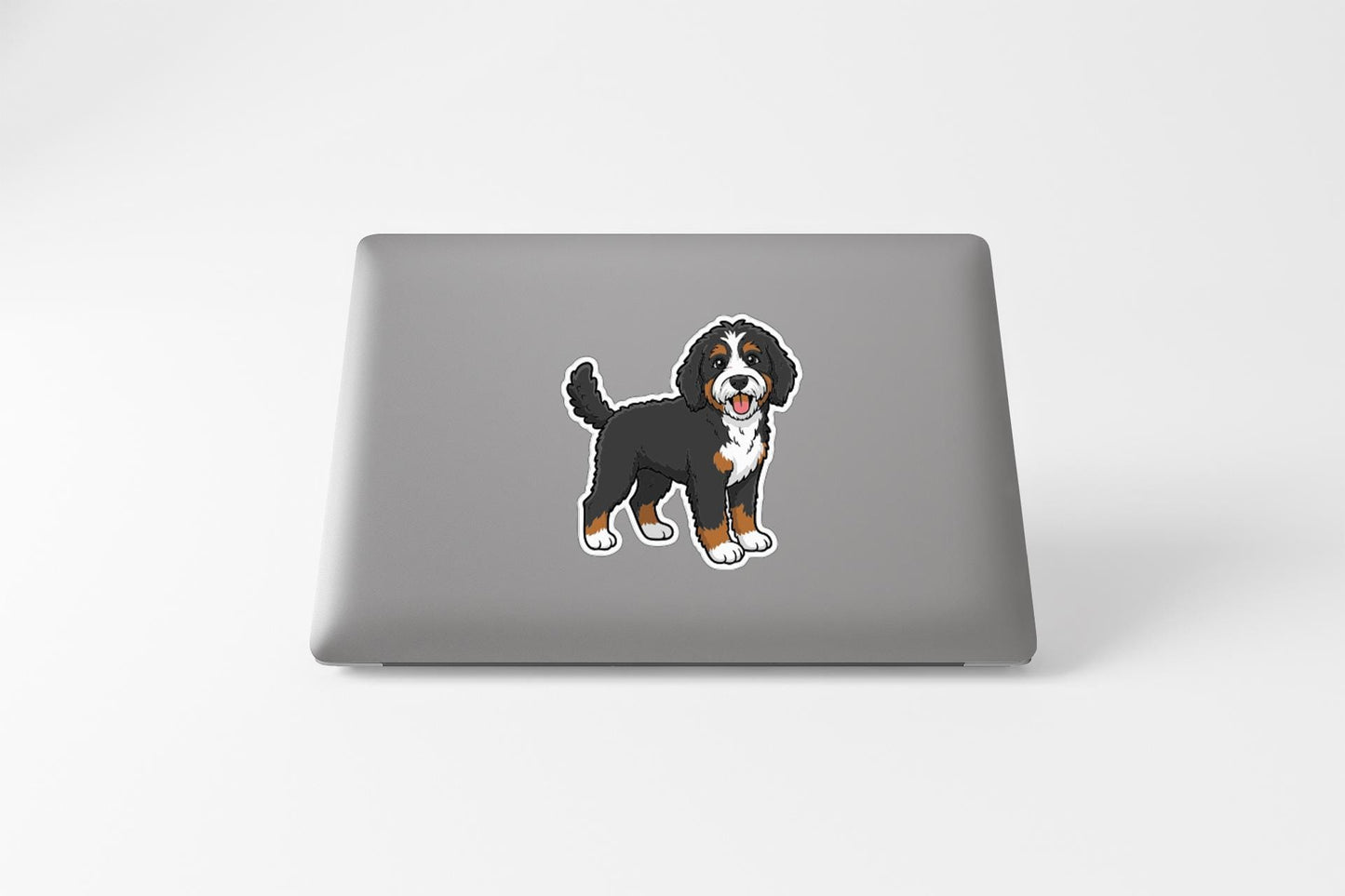 a sticker of a Bernese mountain dog on a laptop.