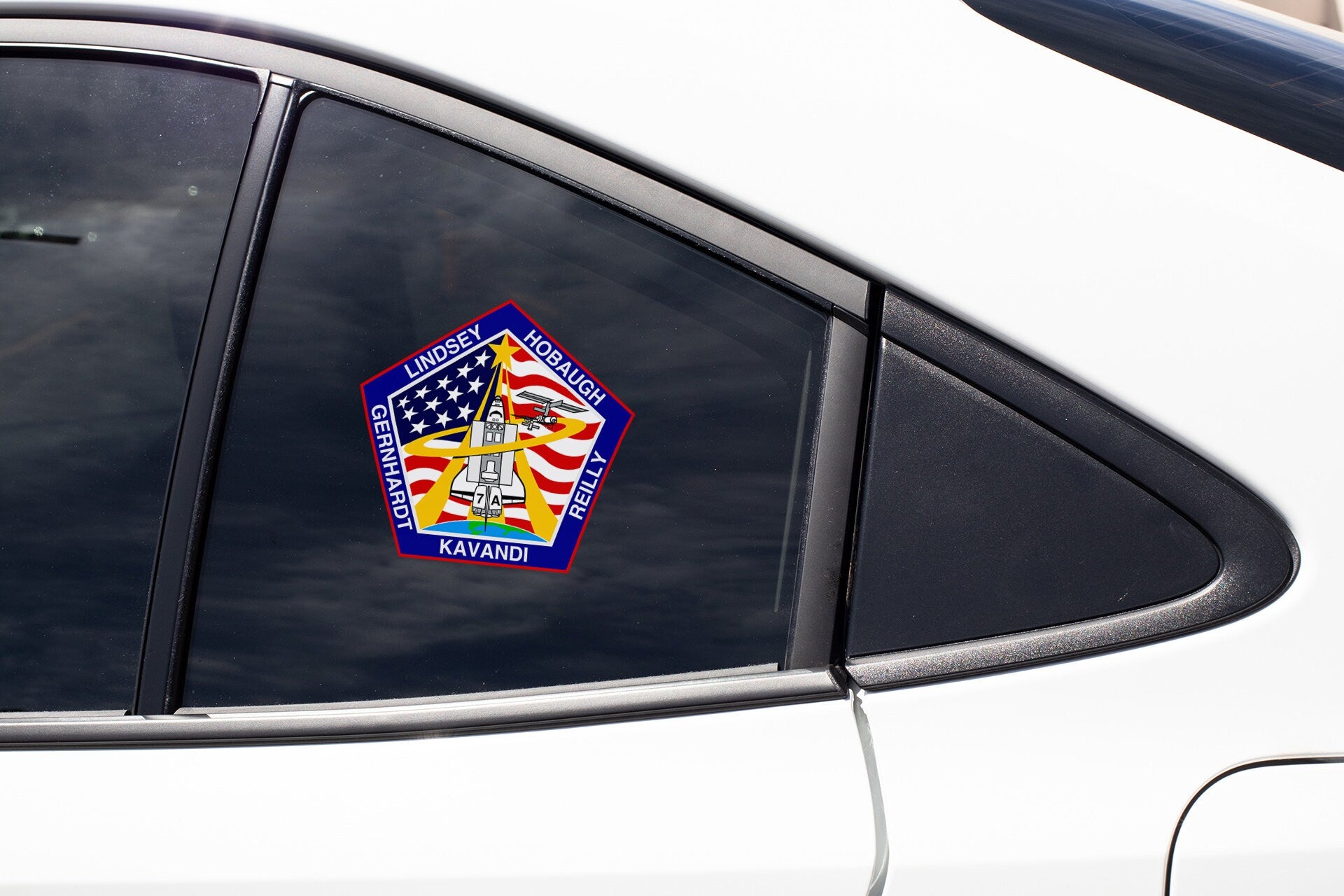 a sticker on the side of a white car