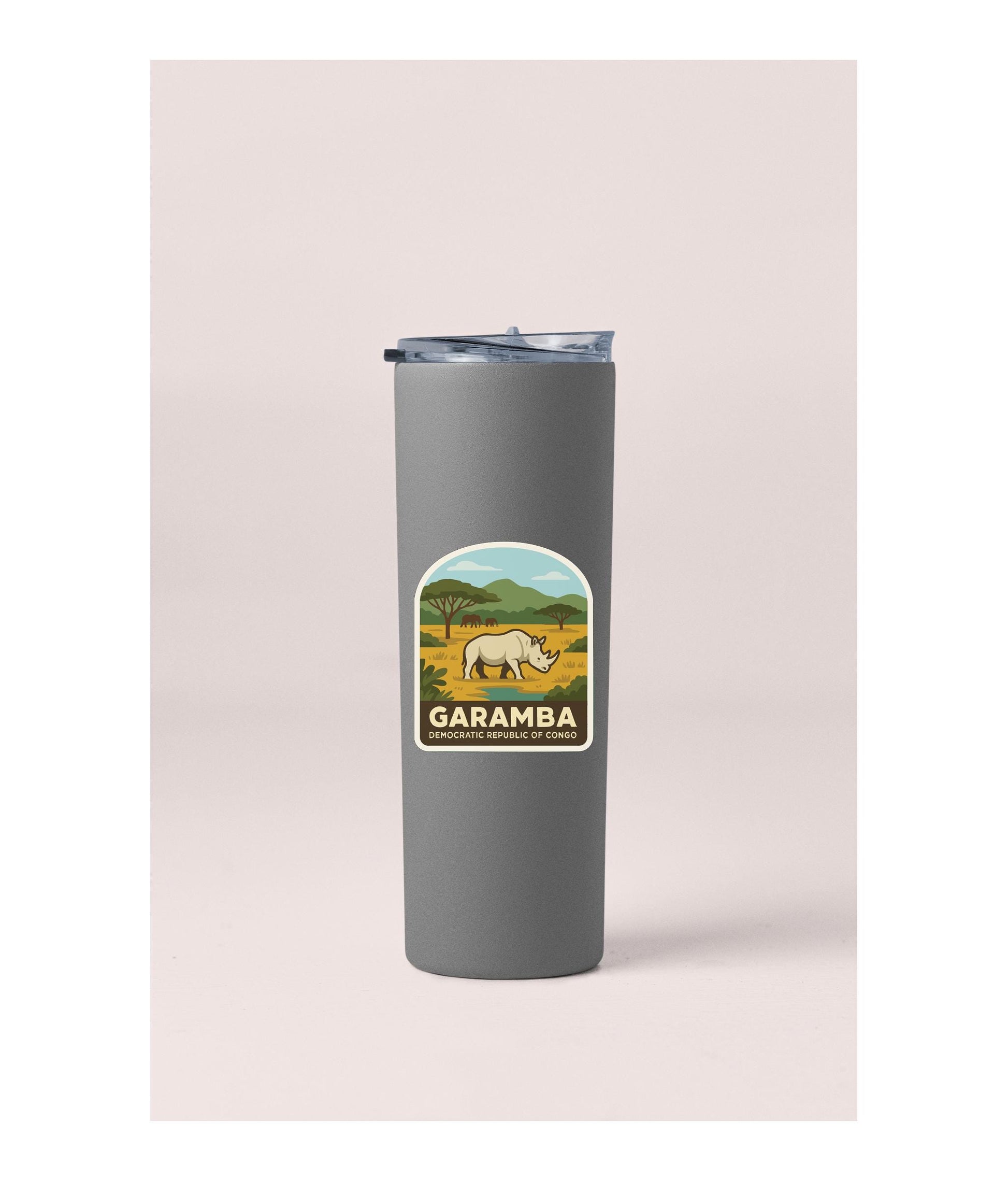 A gray insulated tumbler with a label that says "GARAMBA" and features an illustration of a rhinoceros in a savanna landscape.