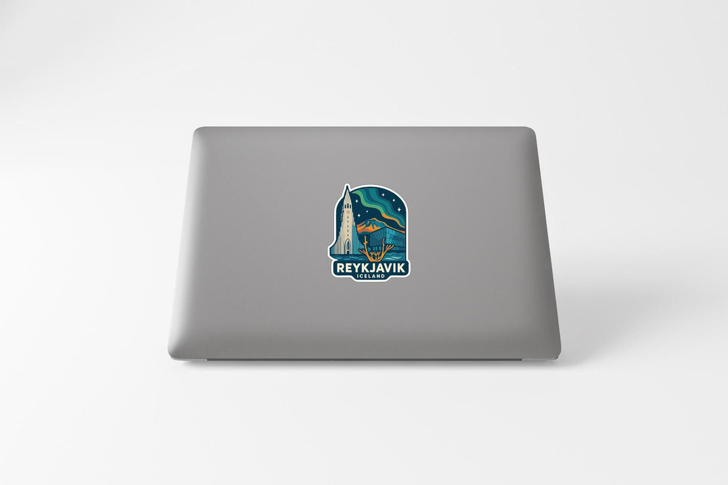 a sticker with a graphic of Reykjavik, Iceland, on the back of a laptop.
