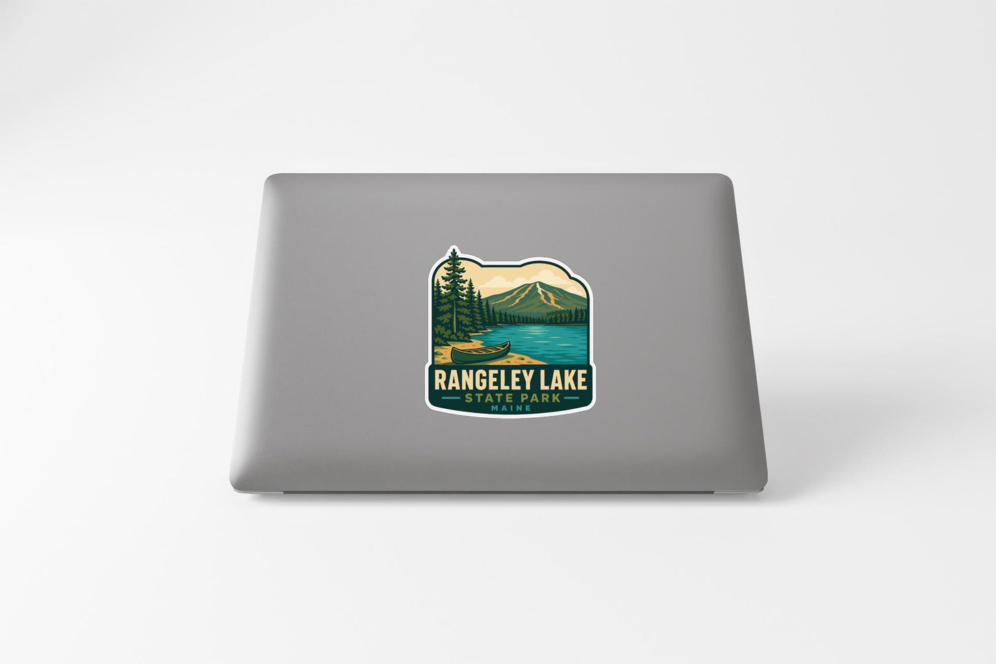 A sticker featuring a scenic landscape with mountains, trees, and a lake, with the text "RANGELEY LAKE STATE PARK" printed on it.
