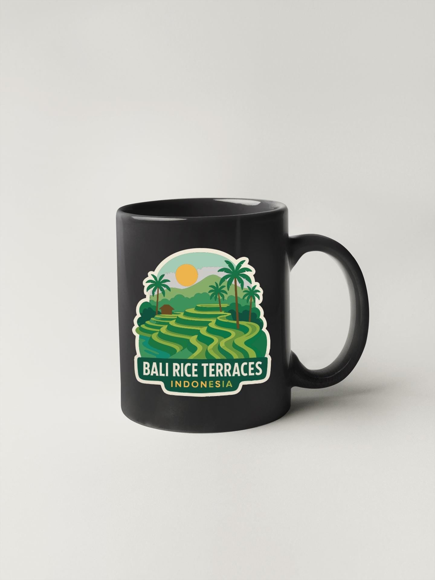 A black coffee mug with a graphic design depicting a tropical landscape with palm trees, hills, and a sun.