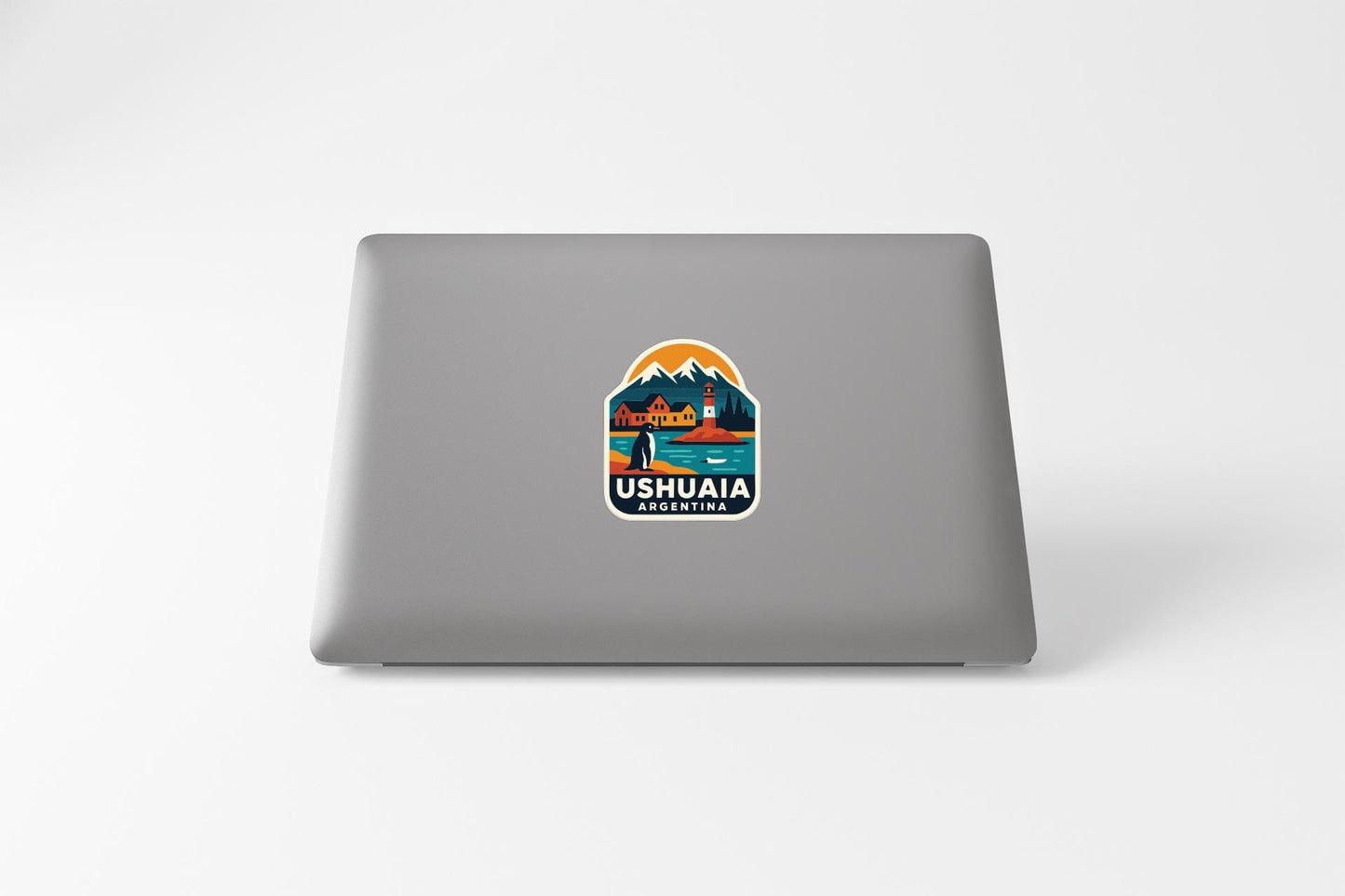 a sticker on the back of a laptop that says "Ushuaia Argentina".