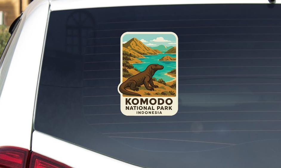A sticker on the rear window of a car that features an illustration of Komodo National Park in Indonesia.