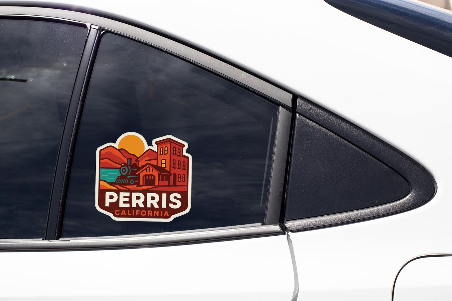A sticker on the side of a car window, featuring a graphic of a cityscape with buildings and a sun.