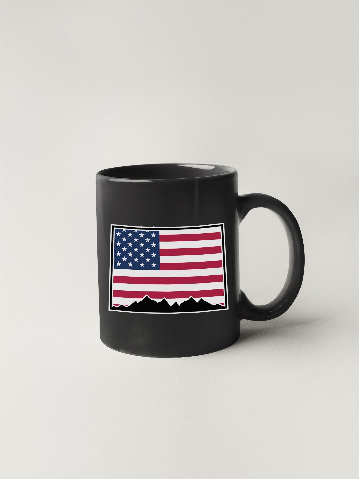 a black mug with an american flag on it