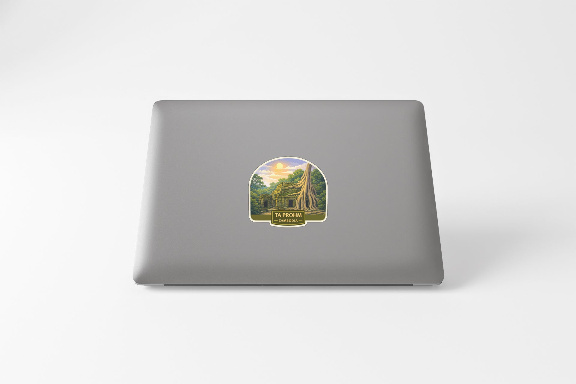 a grey laptop with a sticker depicting a tropical landscape, including a temple or building.