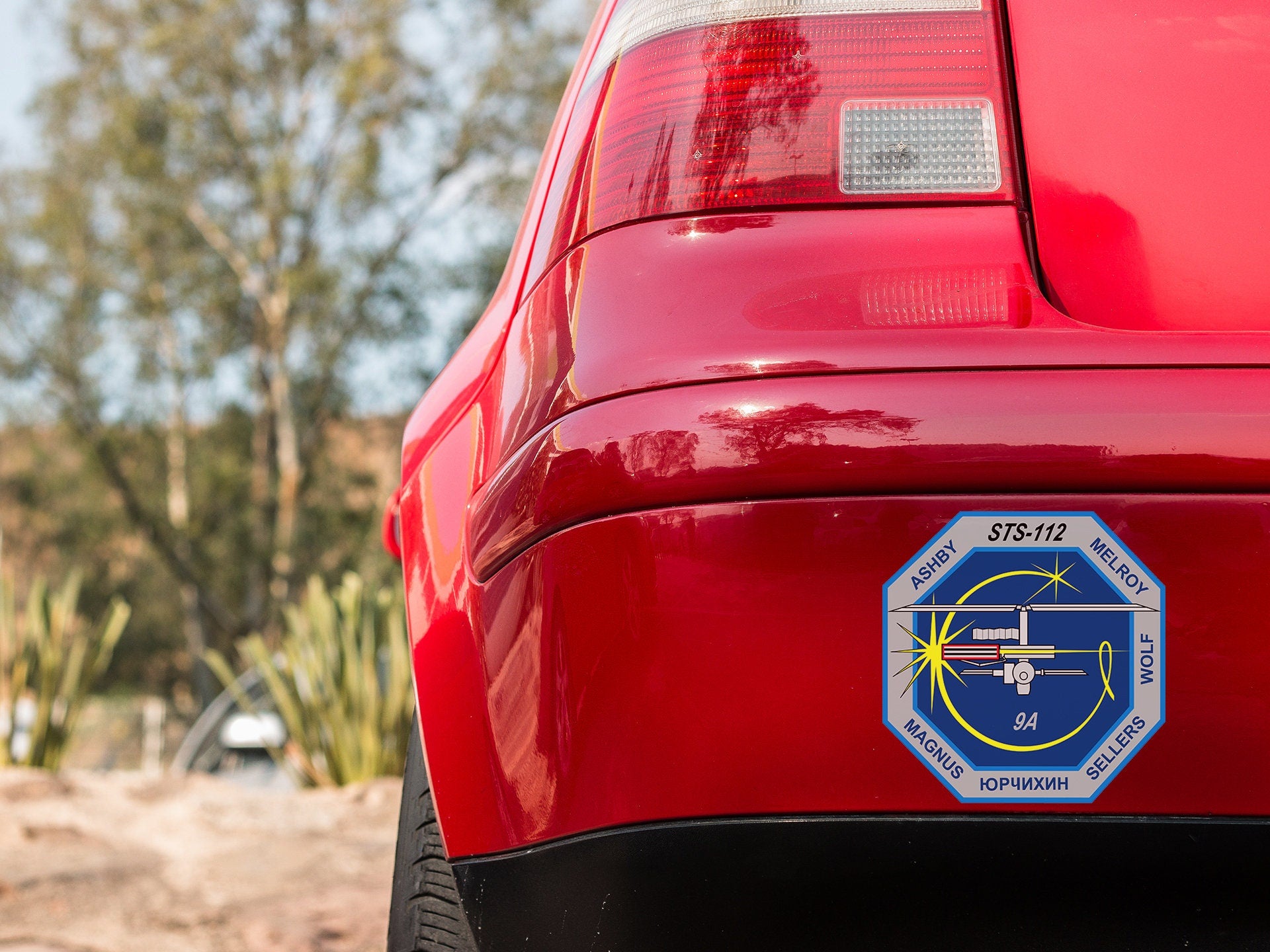 a close up of the back of a red car