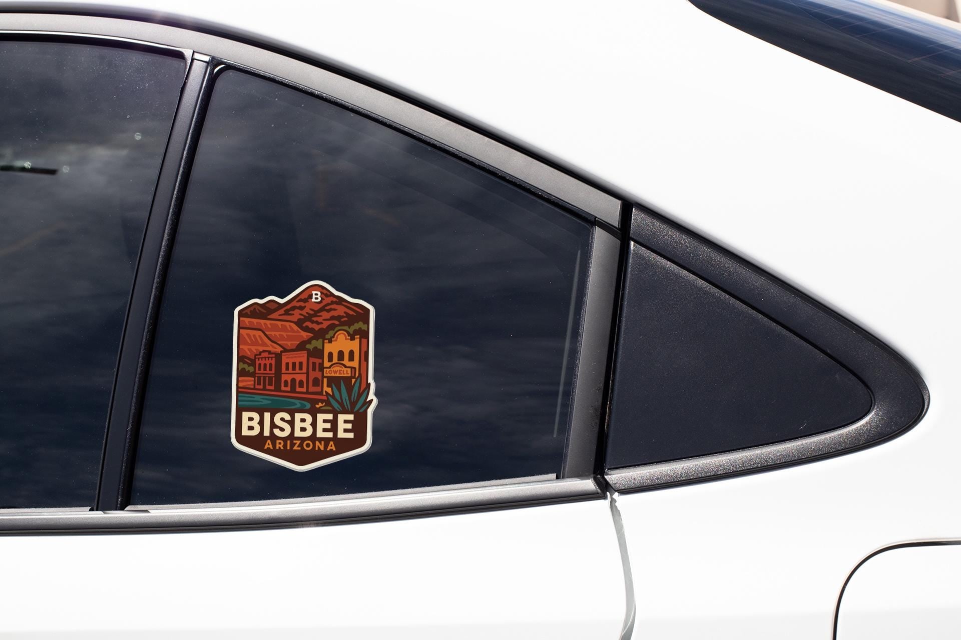 A sticker on the side of a car window that says "BISBEE ARIZONA".