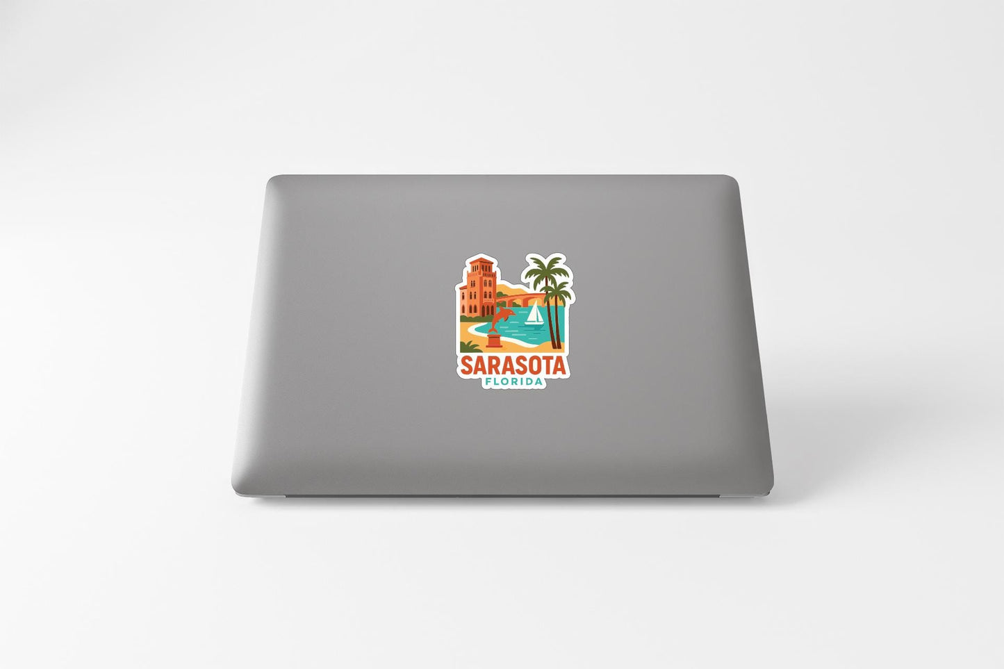 a sticker of a building and palm trees, with the text "SARASOTA FLORIDA" printed on it.