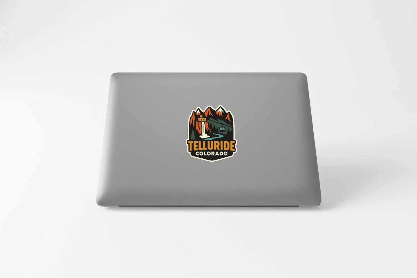 a sticker on the back of a laptop that says "Telluride Colorado".