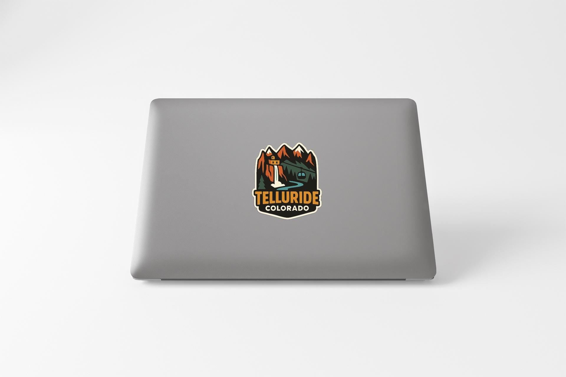 a sticker on the back of a laptop that says "Telluride Colorado".
