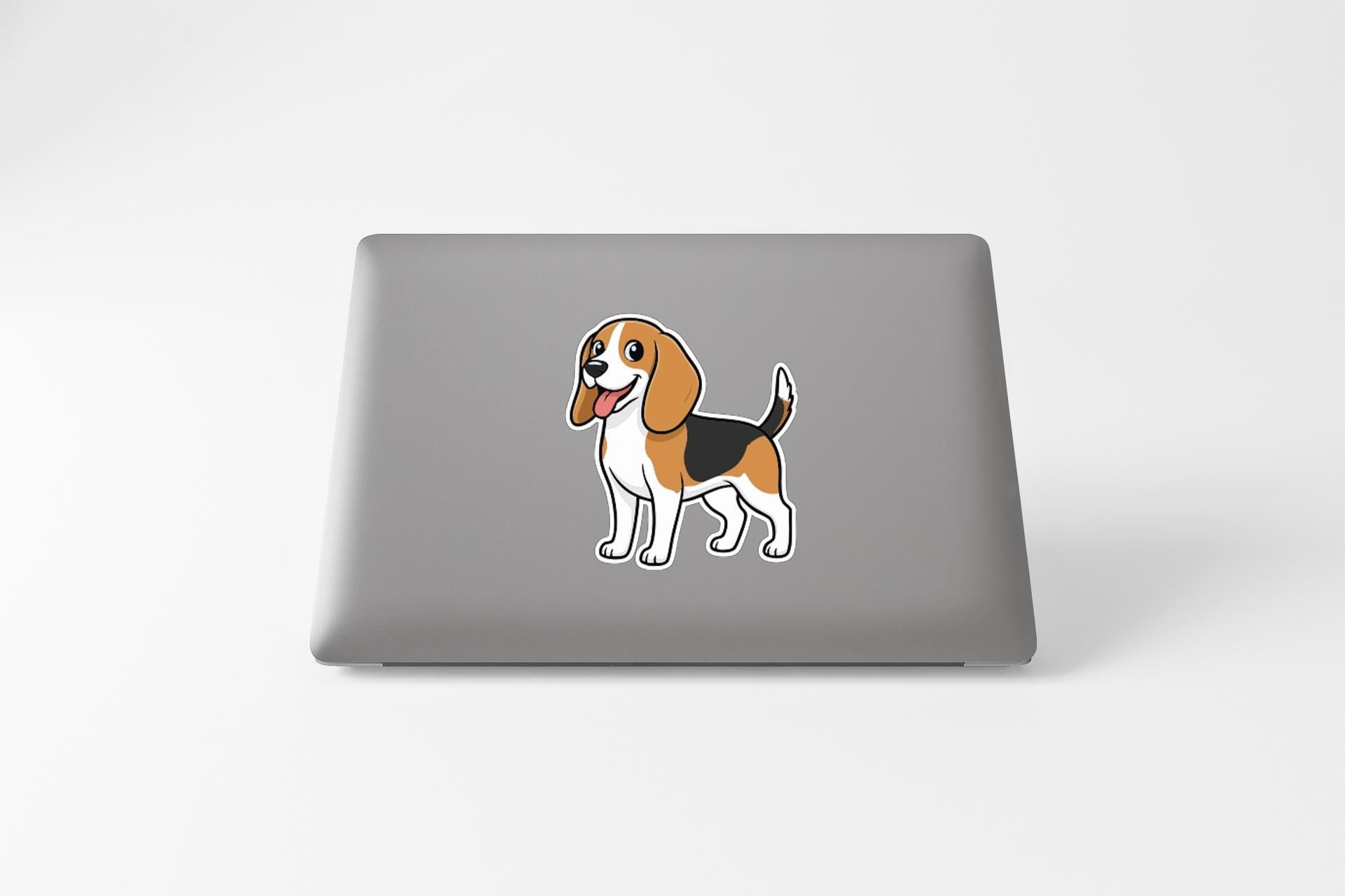 A sticker of a cartoon beagle dog is displayed on the back of a laptop computer.