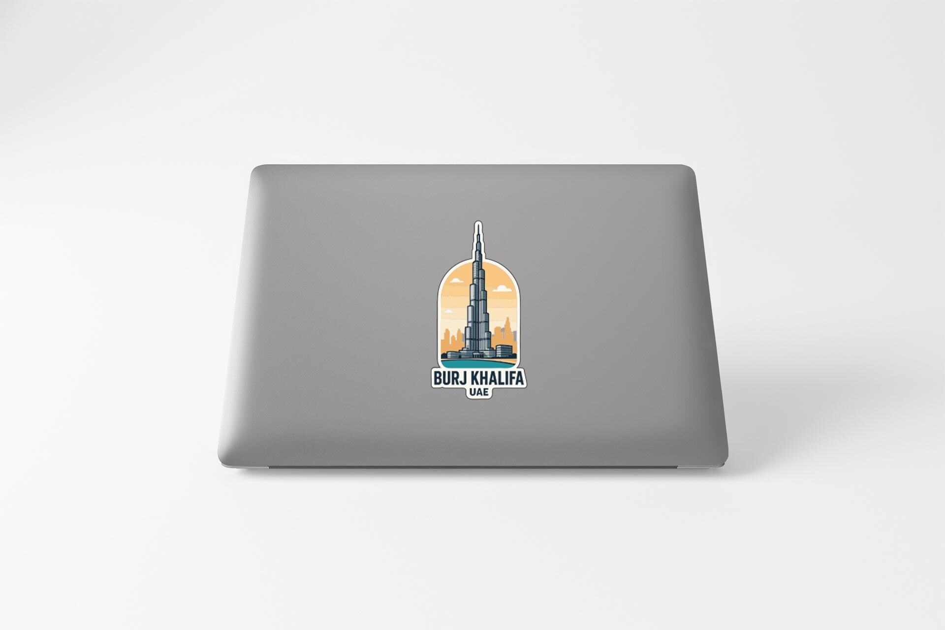 A sticker depicting the Burj Khalifa, the tallest building in the world, on the back of a laptop computer.