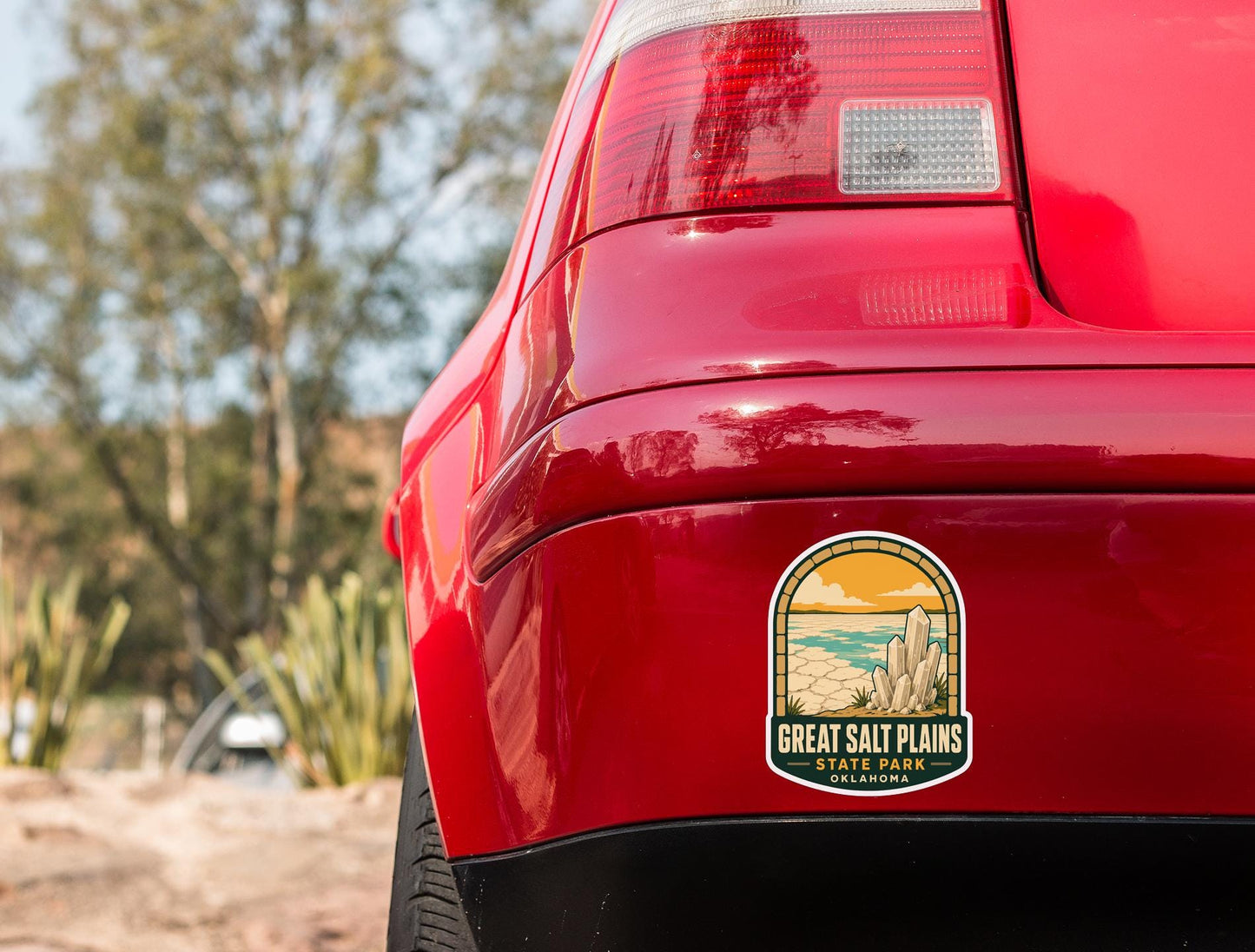 the rear end of a red car with a sticker on the trunk that says "Great Salt Plains State Park, Oklahoma".