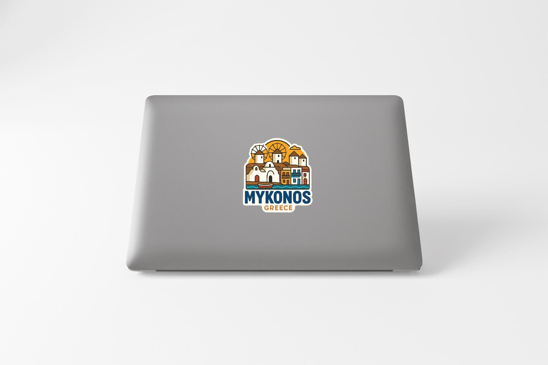 a sticker with a graphic of a Greek village, along with the text "MYKONOS GREECE".