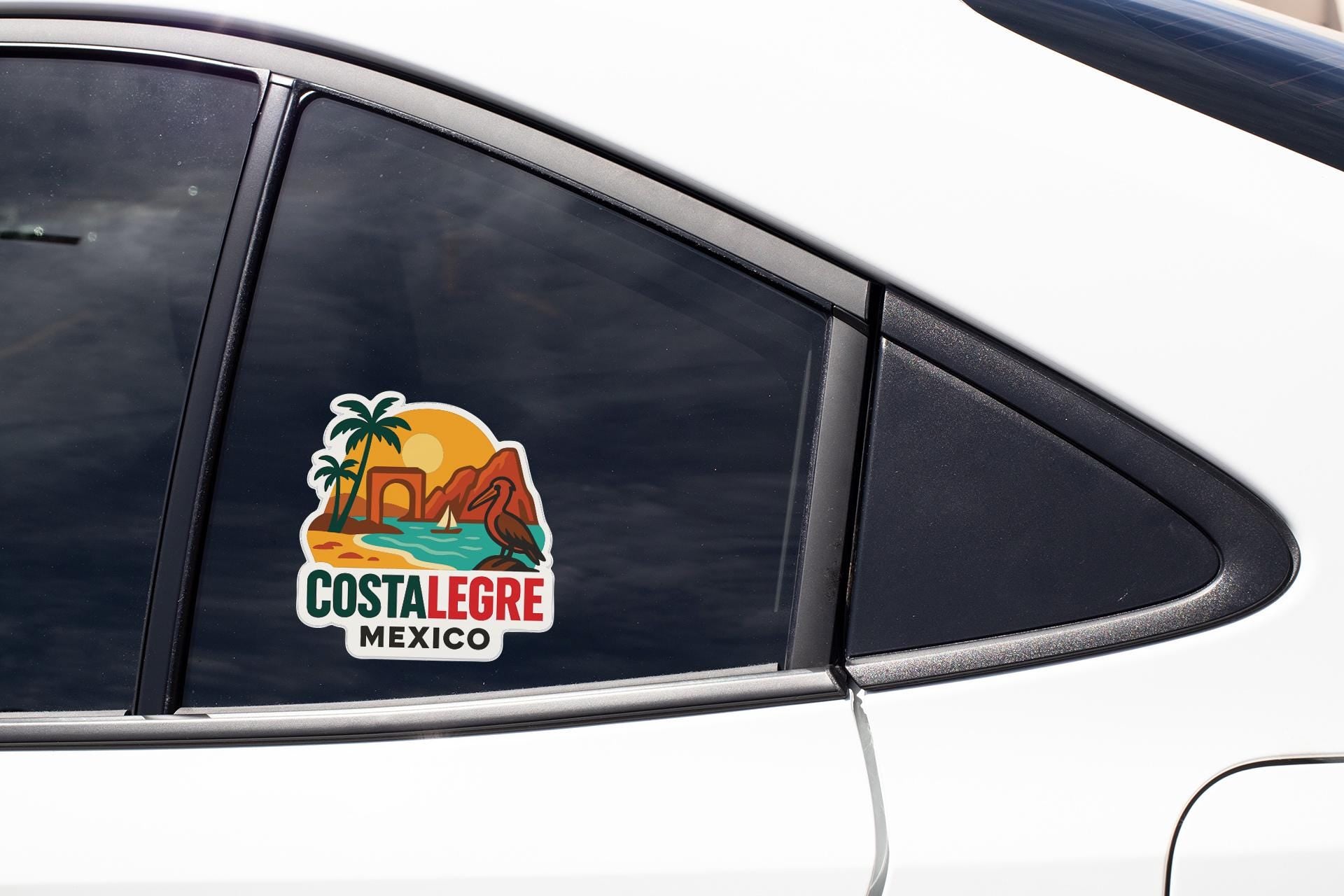 A sticker on the side of a car window, depicting a tropical beach scene with palm trees and mountains.