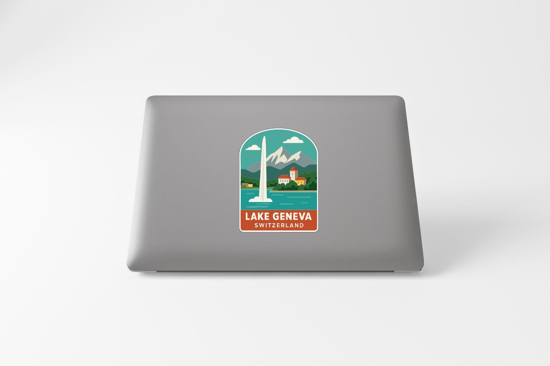 A sticker on the back of a laptop, depicting a scenic view of Lake Geneva, Switzerland.