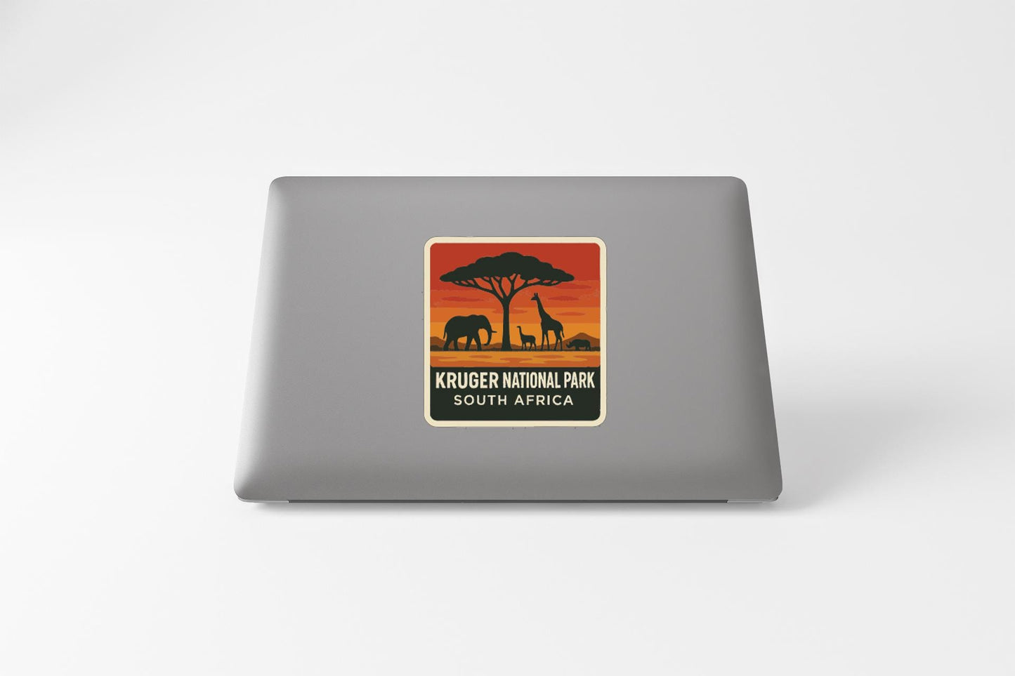 a sticker with a silhouette of an elephant and a giraffe, along with the text "KRUGER NATIONAL PARK SOUTH AFRICA" printed on it.