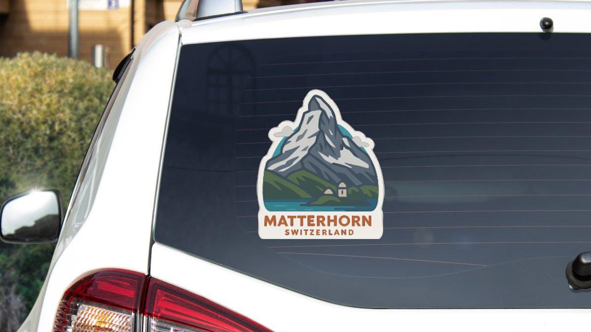 A sticker on the rear window of a car, depicting a mountain landscape with the text "MATTERHORN SWITZERLAND".