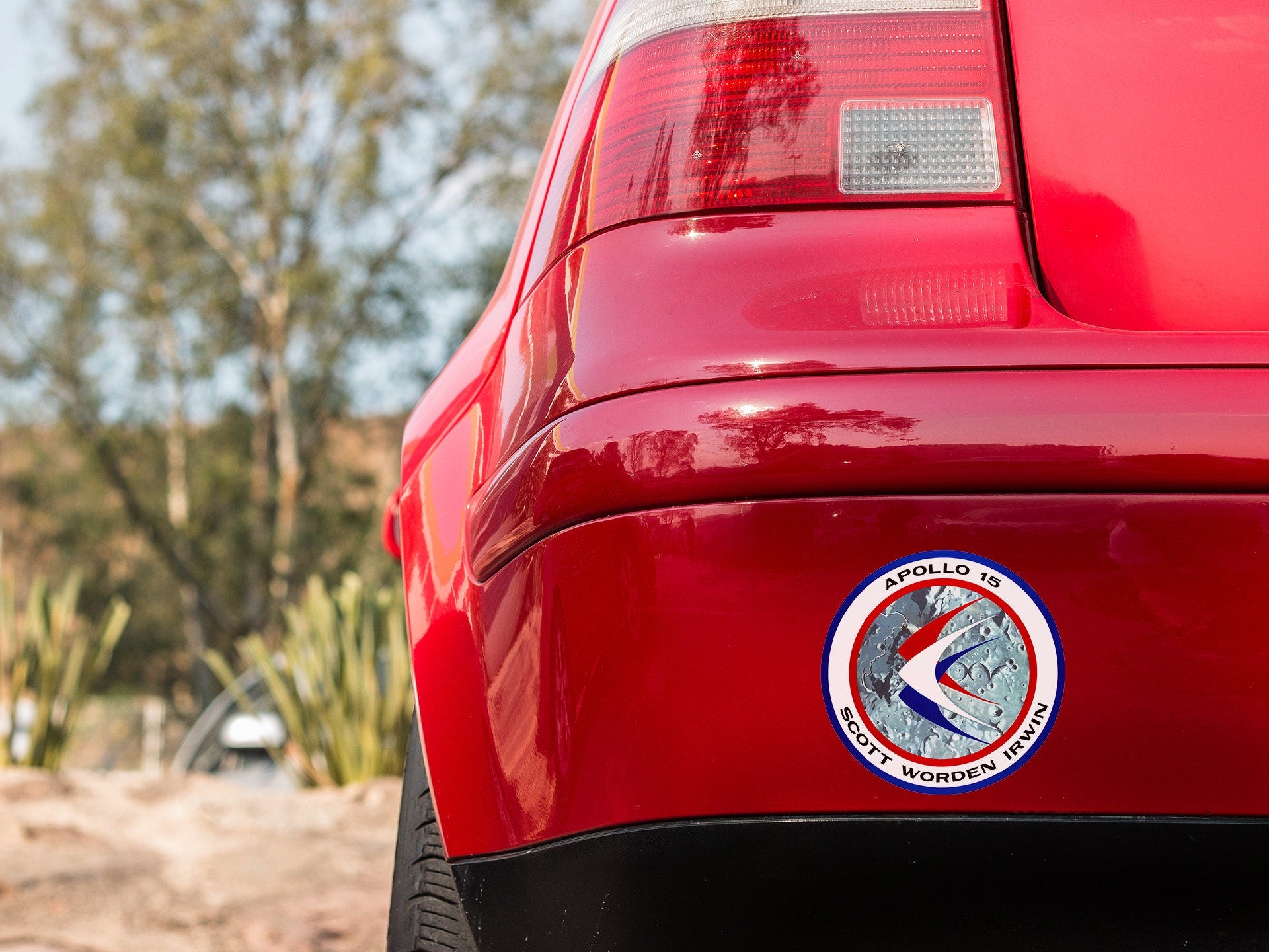 a close up of a red car with a sticker on it