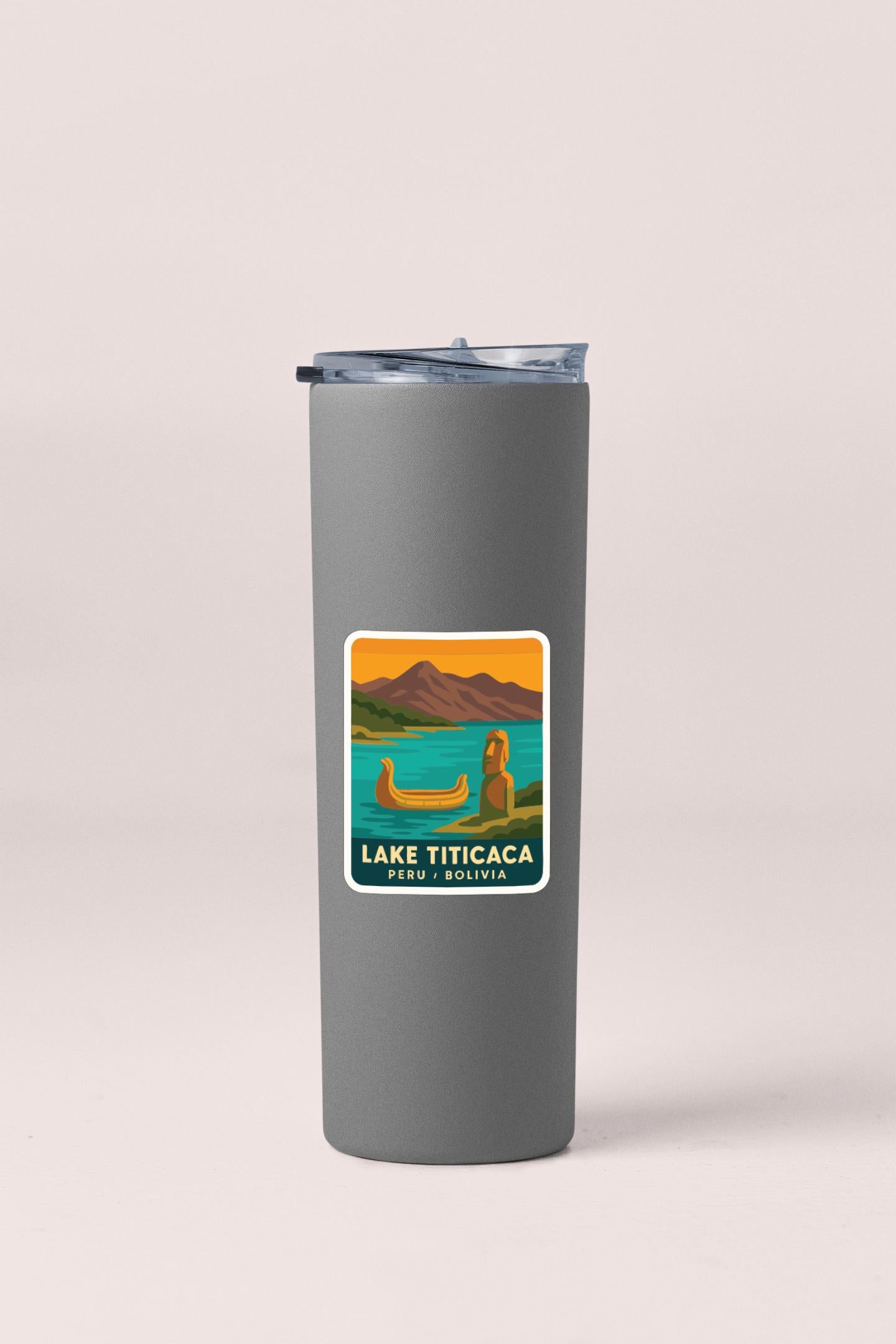 A gray insulated tumbler with a label that says "LAKE TITICACA PERU WOLVIA" on it.