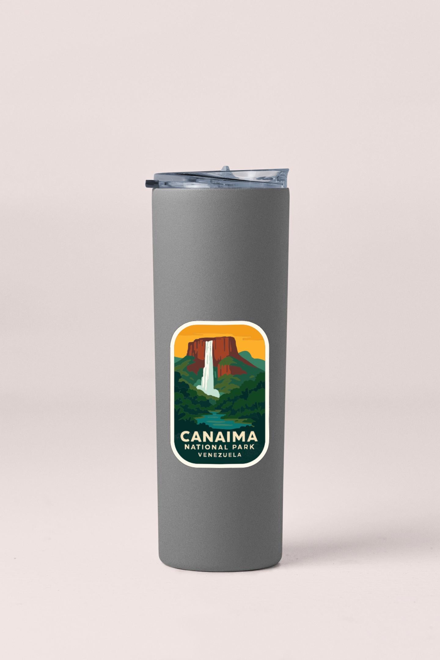 A gray insulated tumbler with a label that features an illustration of the Canaima National Park in Venezuela.