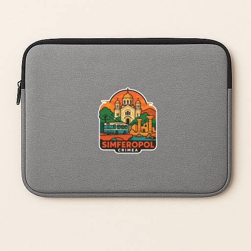 a gray laptop sleeve with a sticker depicting a cityscape and the text "SIMFEROPOL CRIMEA".