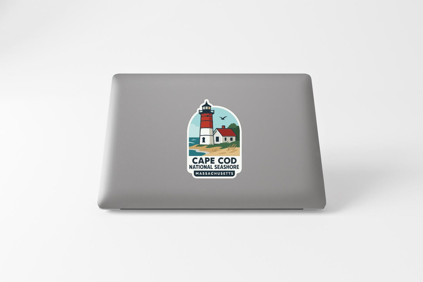 a sticker on a laptop that displays a lighthouse and the text "Cape Cod National Wildlife Refuge Massachusetts".