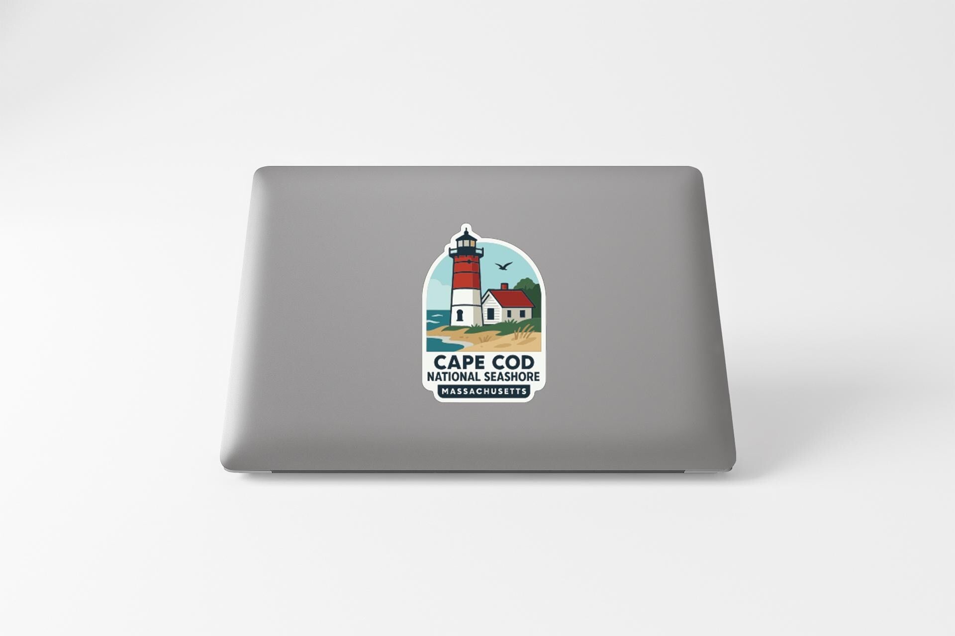 a sticker on a laptop that displays a lighthouse and the text "Cape Cod National Wildlife Refuge Massachusetts".