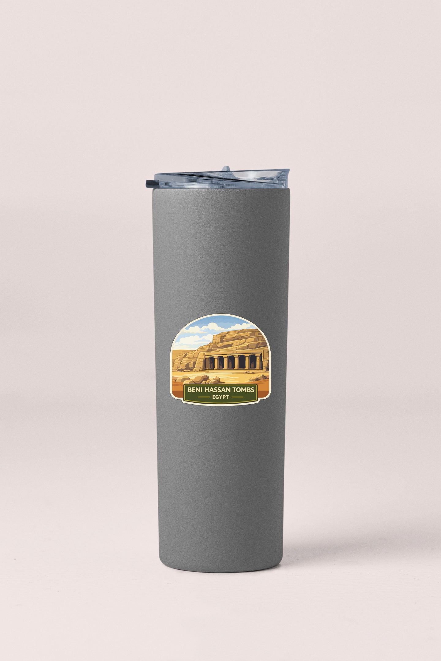 A gray tumbler with a sticker depicting the ancient ruins of Beni Hassan Tomb in Egypt.