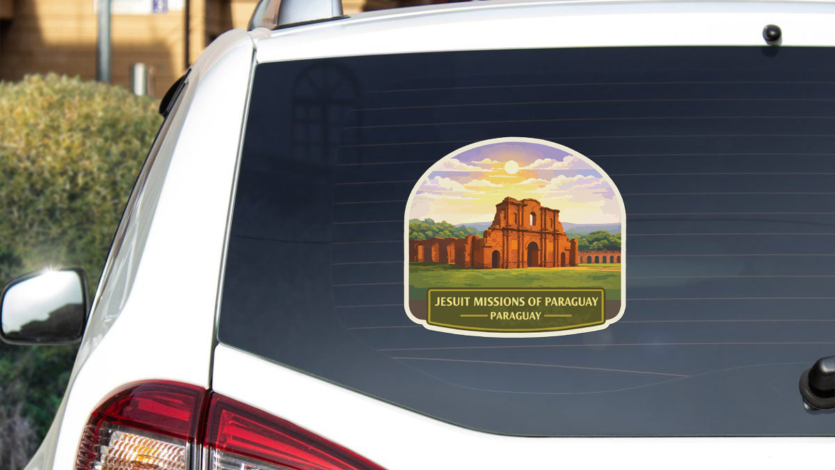 A sticker on the rear window of a white car, depicting the historic building of the Jesuit Missions of Paragay in Paraguay.