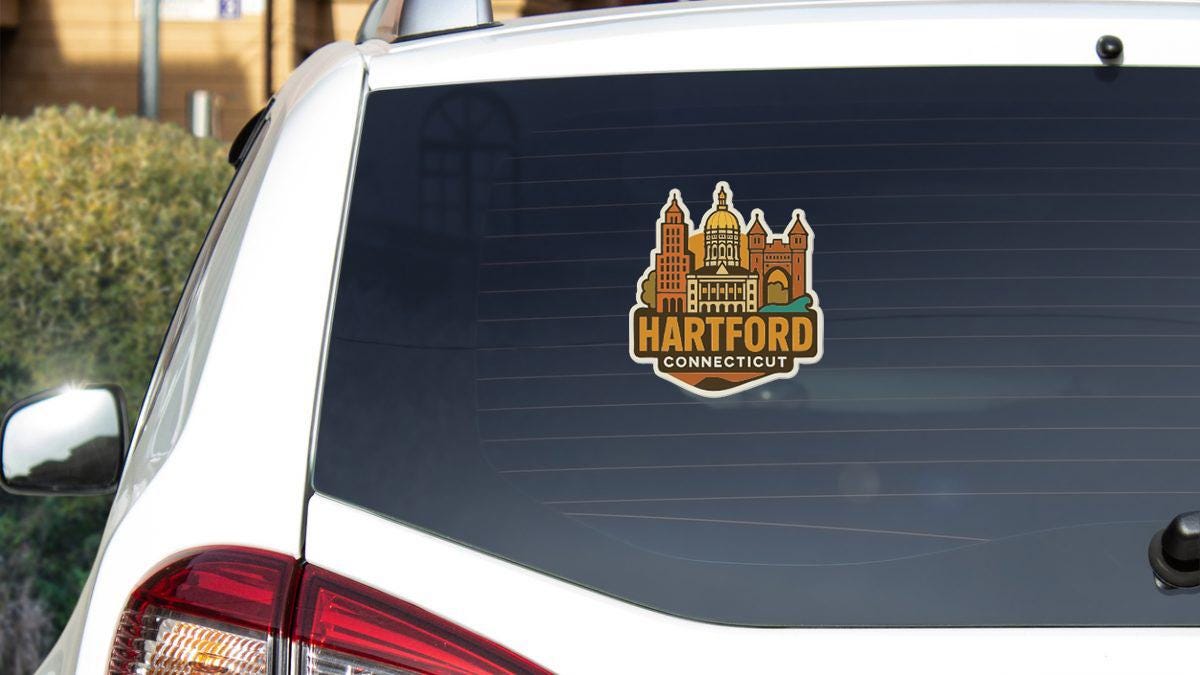 A sticker on the rear window of a white vehicle, displaying the text "HARTFORD CONNECTICUT" along with an illustration of a city skyline.