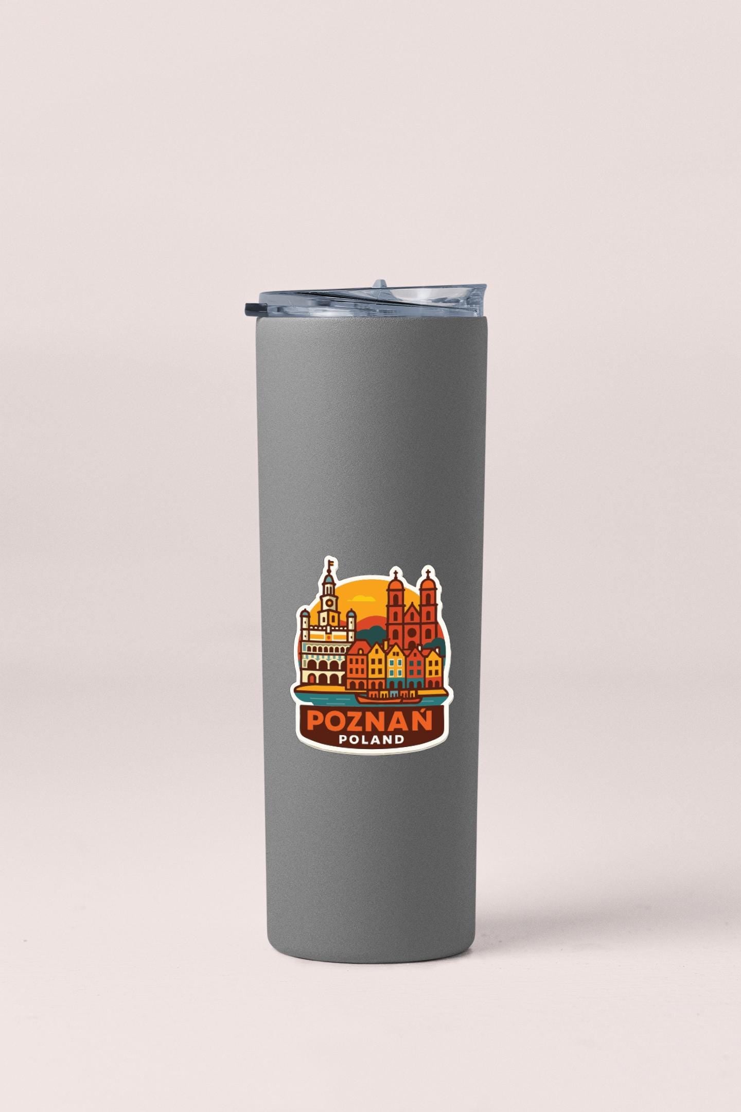 A gray insulated tumbler with a sticker depicting the cityscape of Poznan, Poland.
