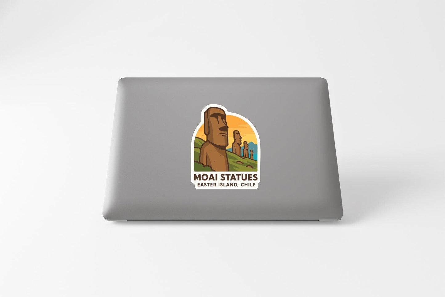 a sticker with an illustration of Moai statues on a laptop.