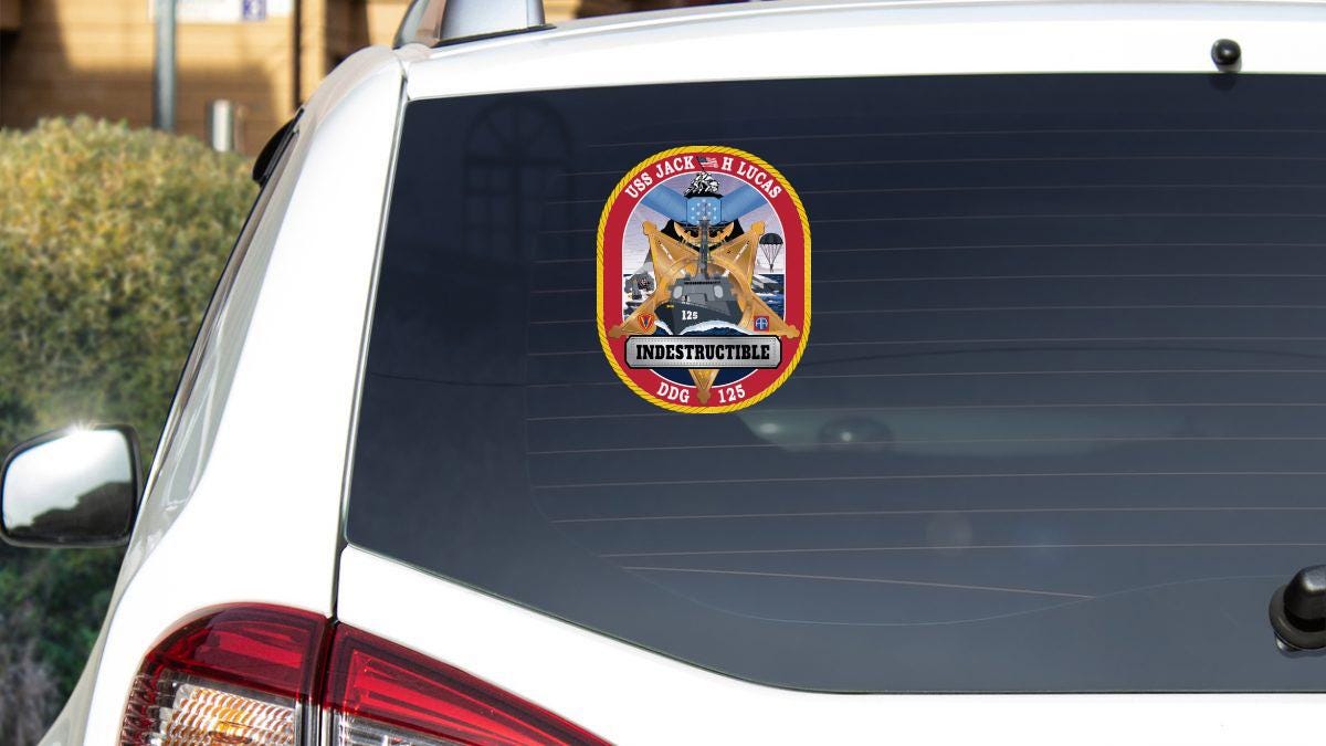 a sticker on the back of a white car