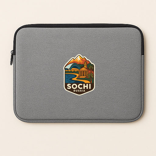 A gray laptop sleeve with a sticker depicting a scenic landscape and the text "SOCI RUSSIA".