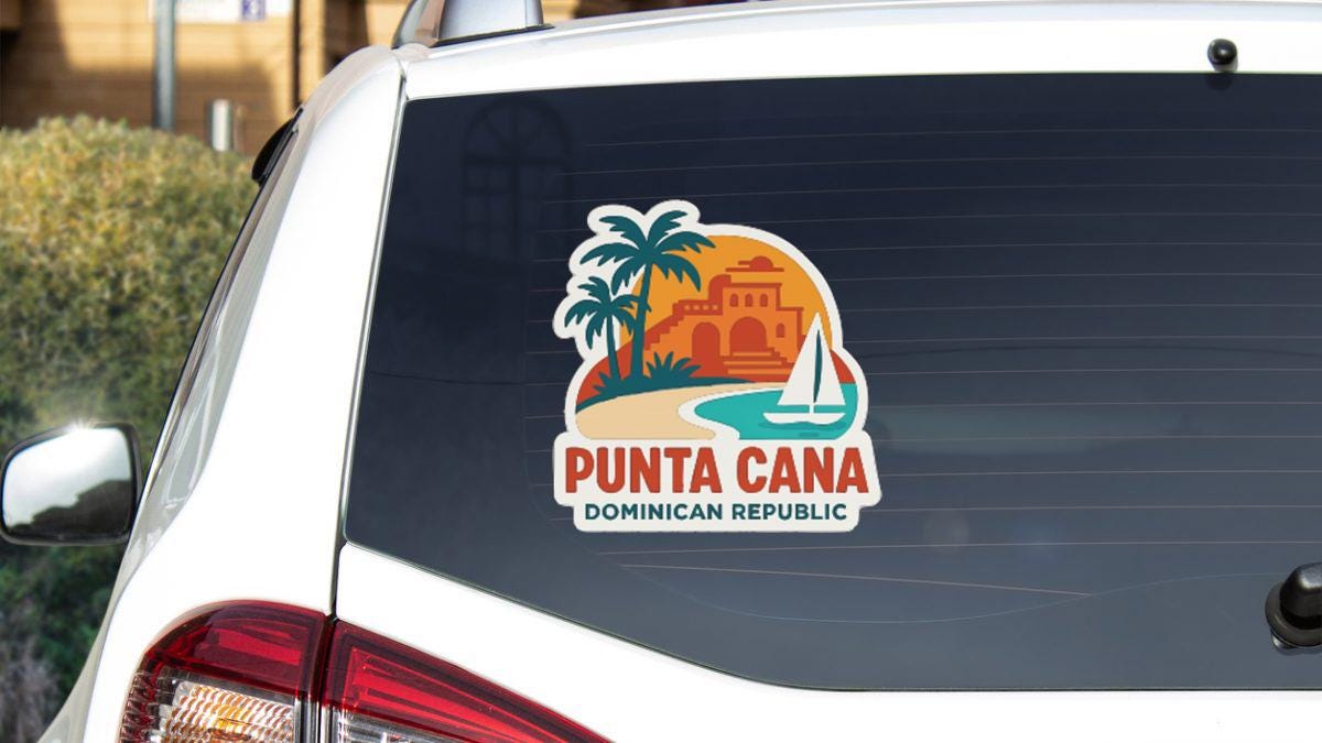 A sticker on the rear window of a car, depicting a tropical beach scene with palm trees, a building, and a sailboat.